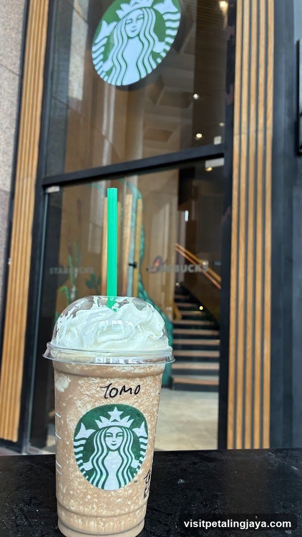 Starbucks drink in front of storefront