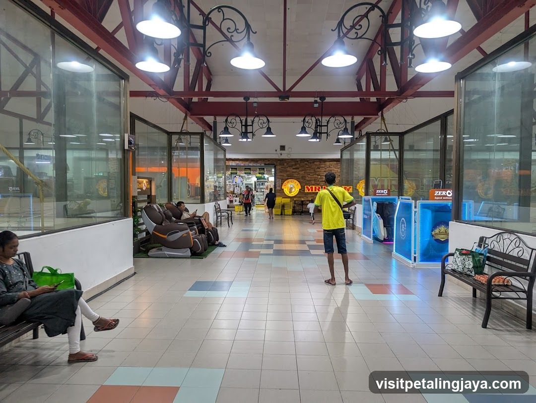 Shopping Mall Interior with Massage Chairs and Retail Displays