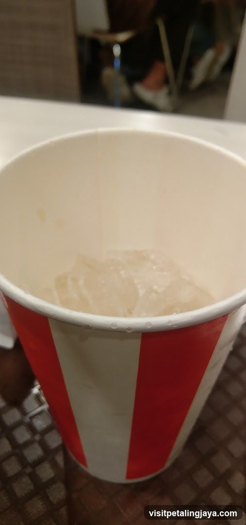 Red and white striped cup with ice