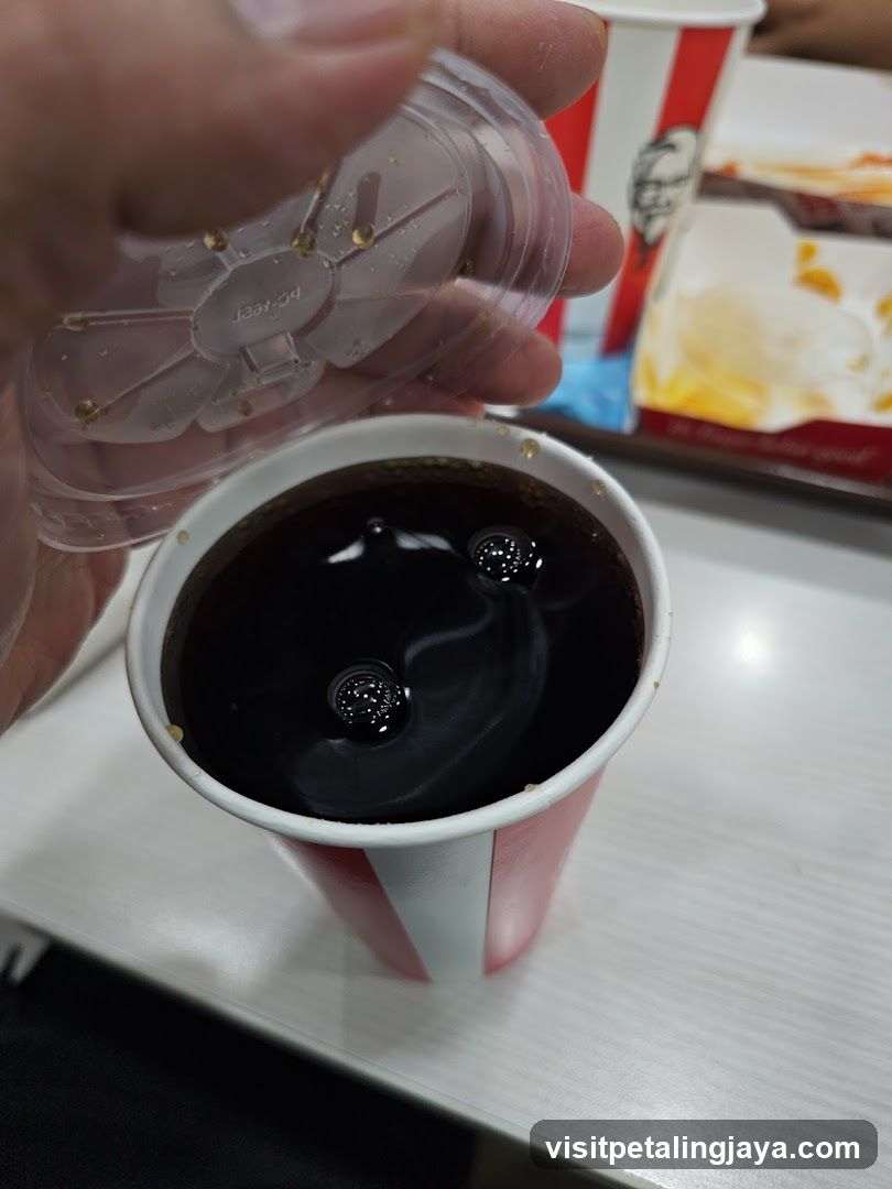 Hand holding drink cup with lid