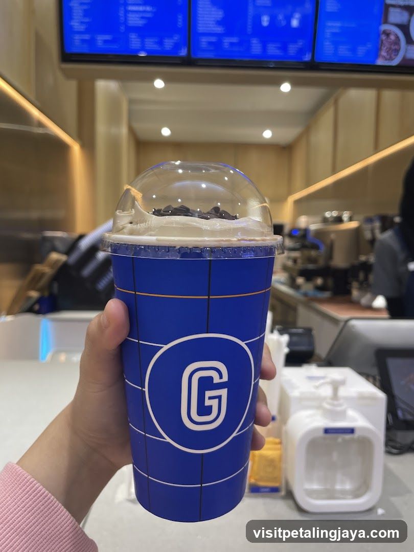 Hand holding a branded drink