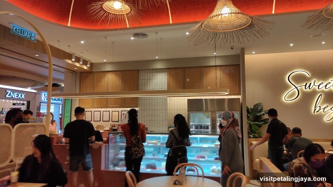 Interior of a cafe with display cases and seating