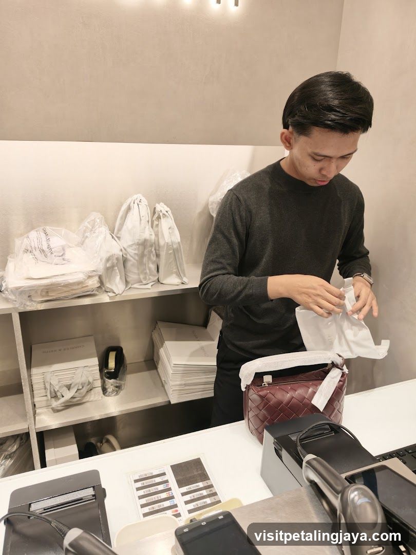 Sales associate packaging a handbag