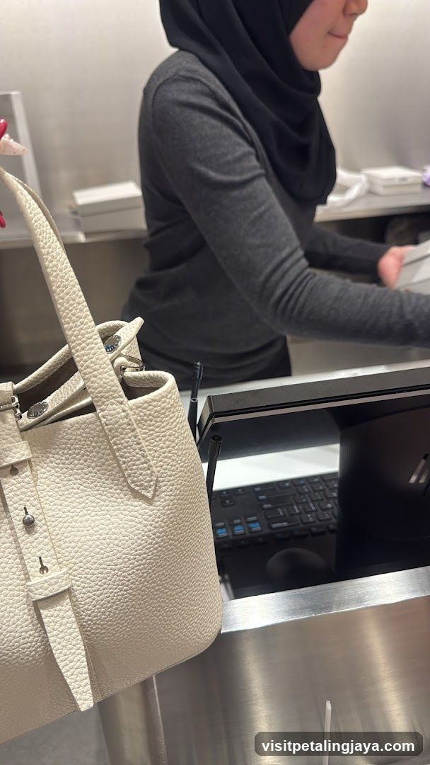 Retail Counter with Handbag and Employee
