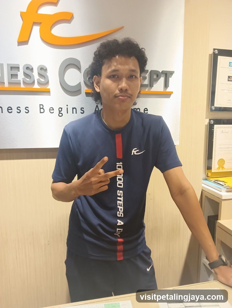 Man in front of Fitness Concept sign