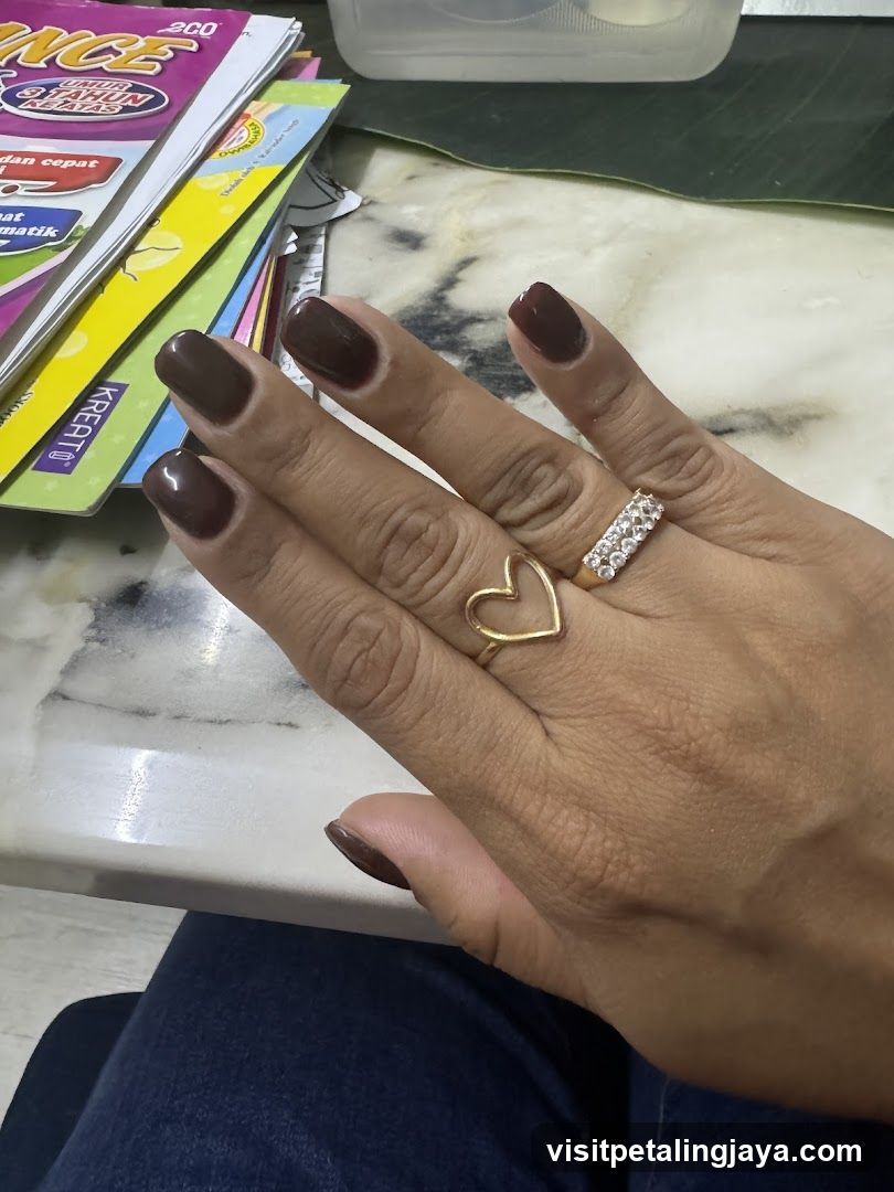 Woman's Hand with Rings and Dark Nail Polish