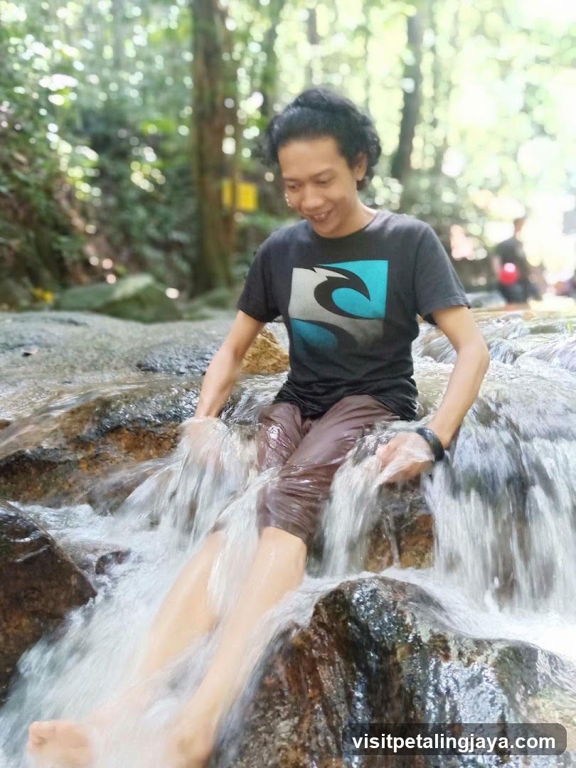 Man sitting in a waterfall