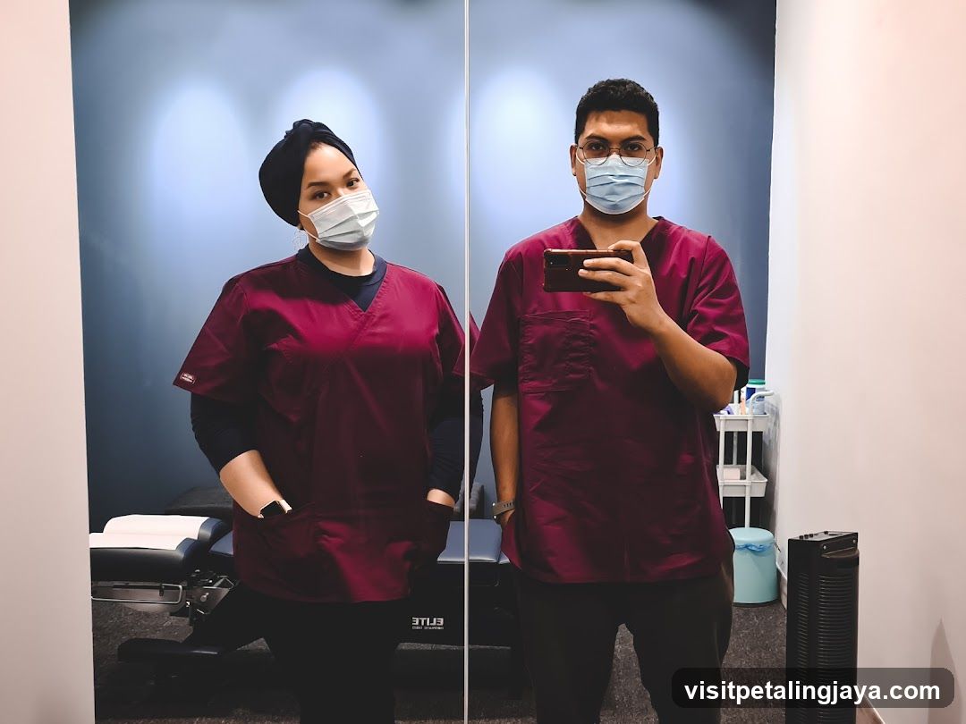 Two people in scrubs taking a mirror selfie