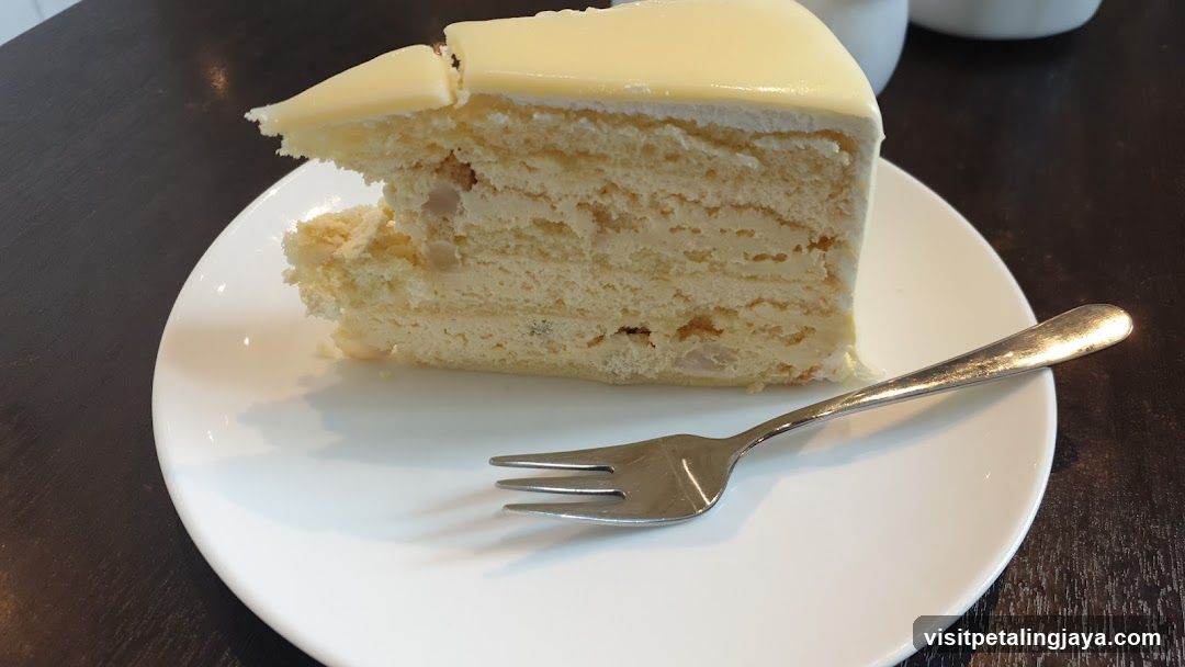 Slice of layered cake with white frosting