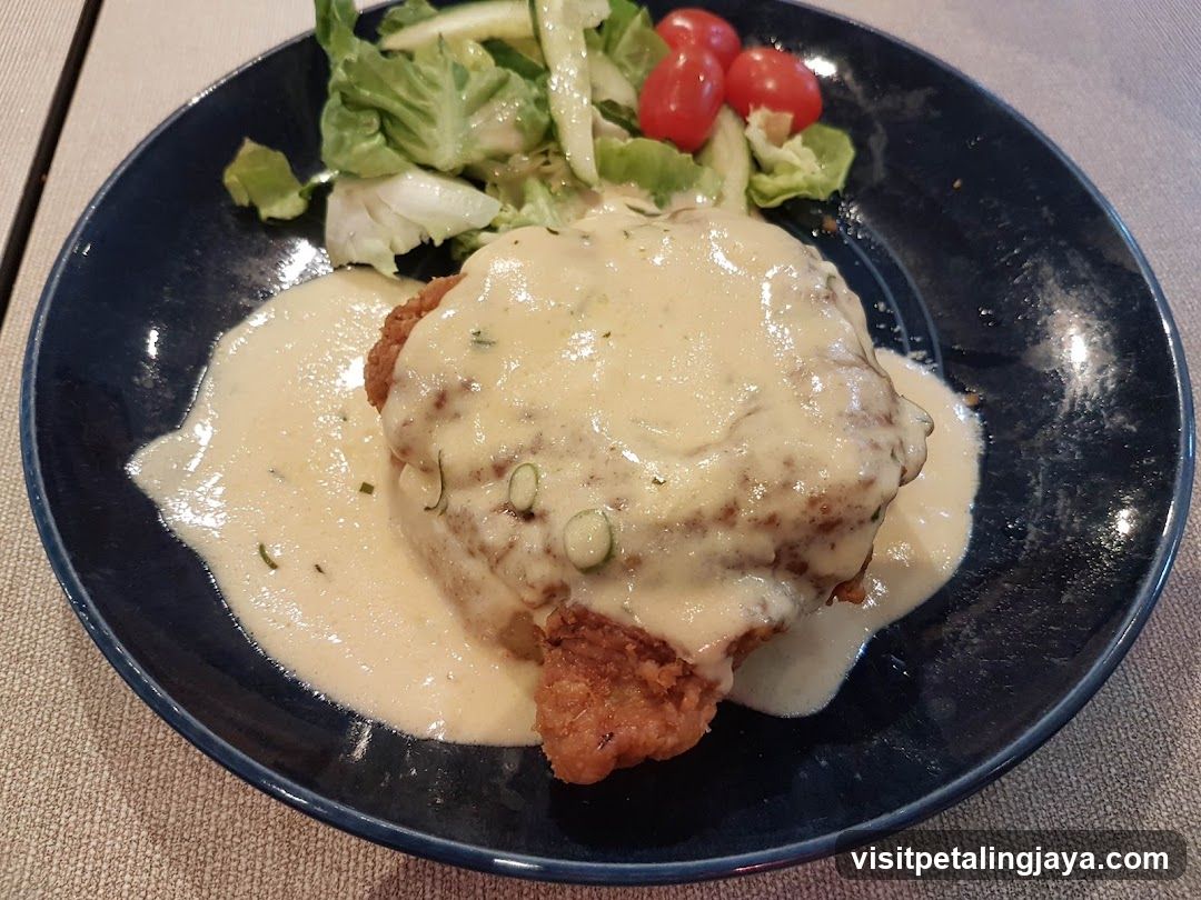 Chicken dish with sauce and salad