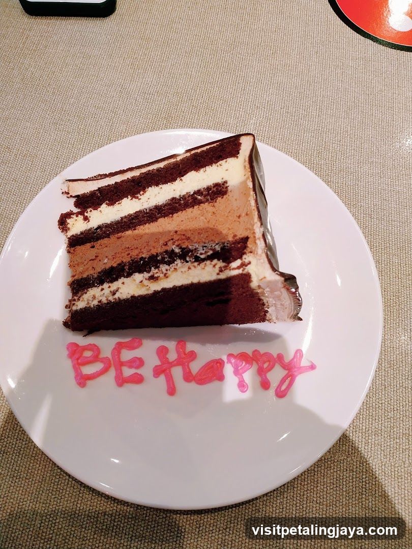 Slice of Chocolate Cake with "BE Happy" Message