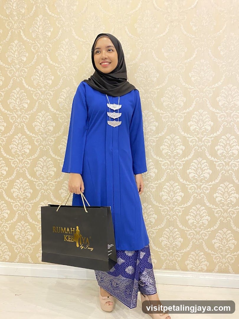 Woman in Blue Kebaya Holding Shopping Bag
