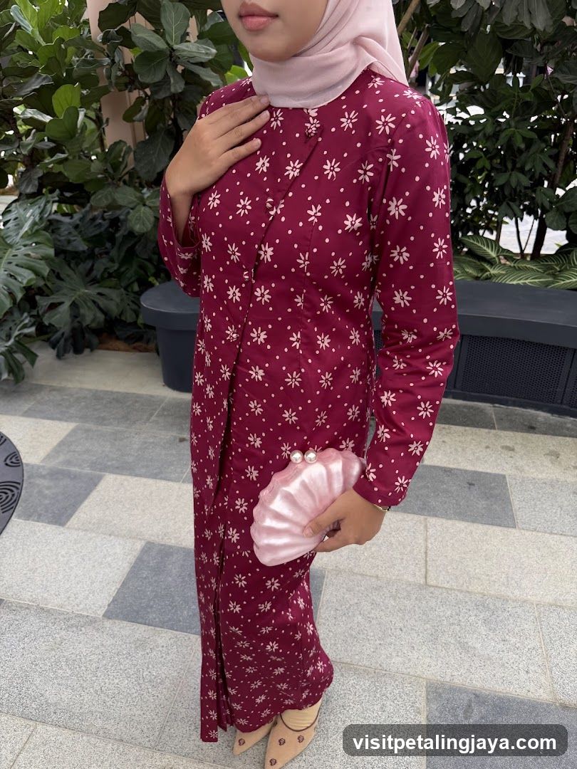 Woman in a floral dress holding a shell-shaped clutch