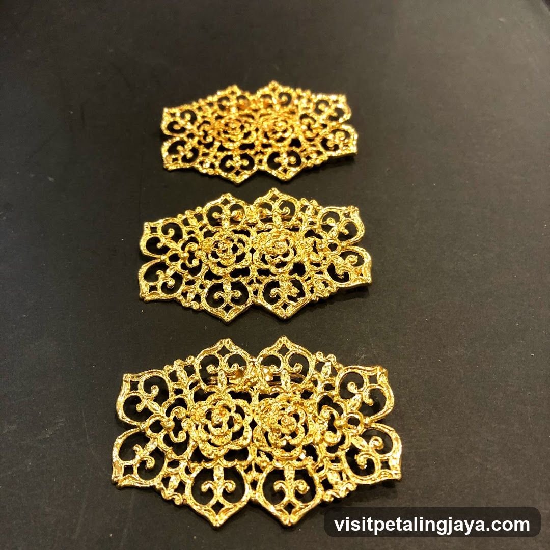 Three ornate gold brooches