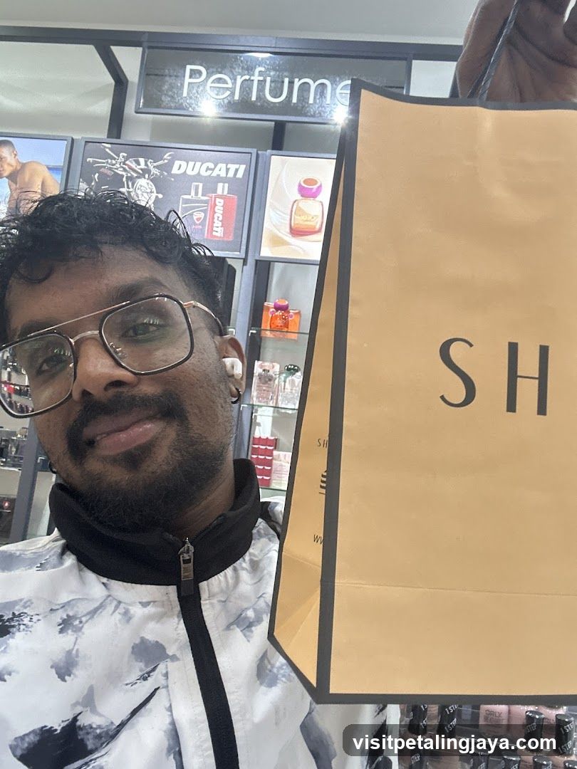 Man holding a shopping bag in a perfume store