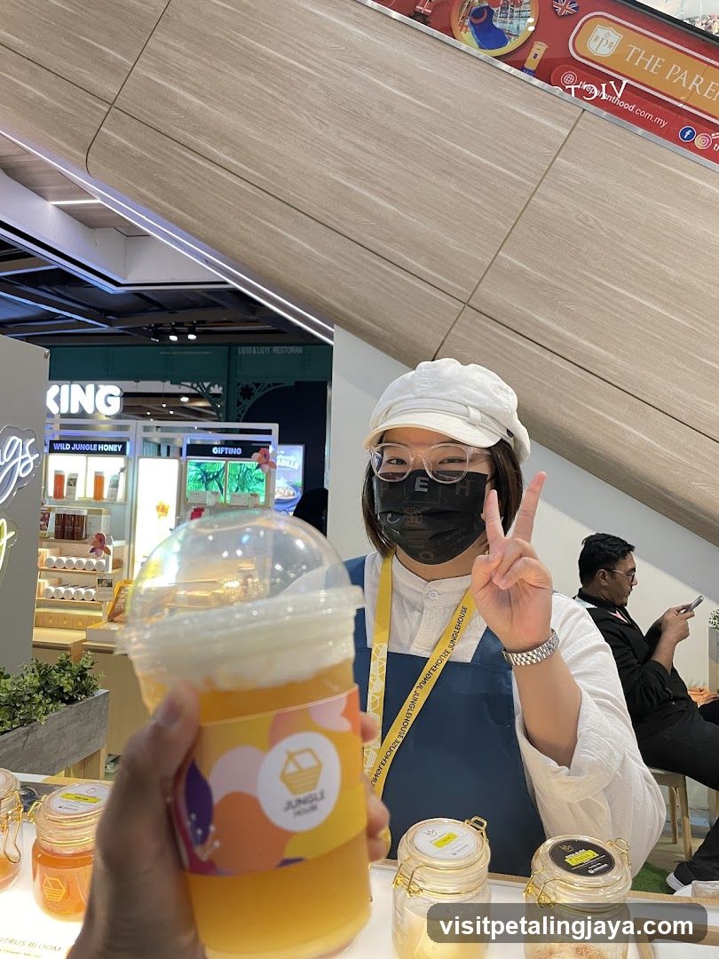 Woman holding a drink at a stall