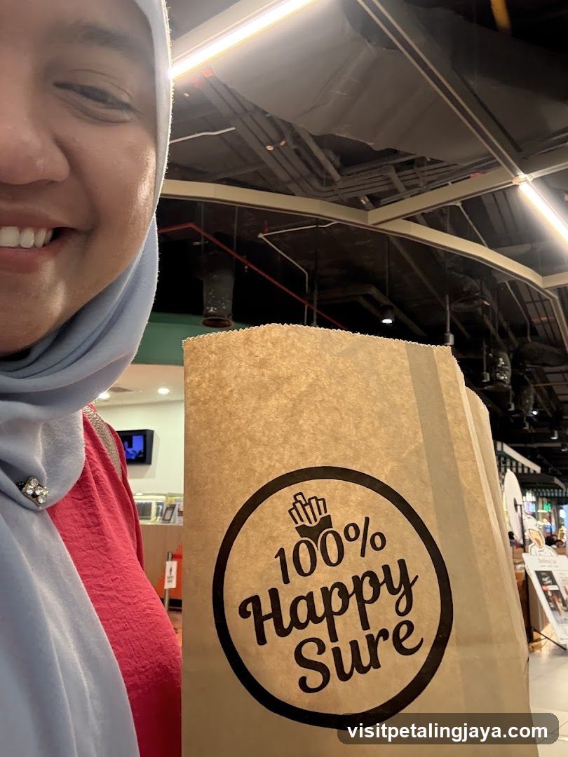 Person holding a paper bag with a logo
