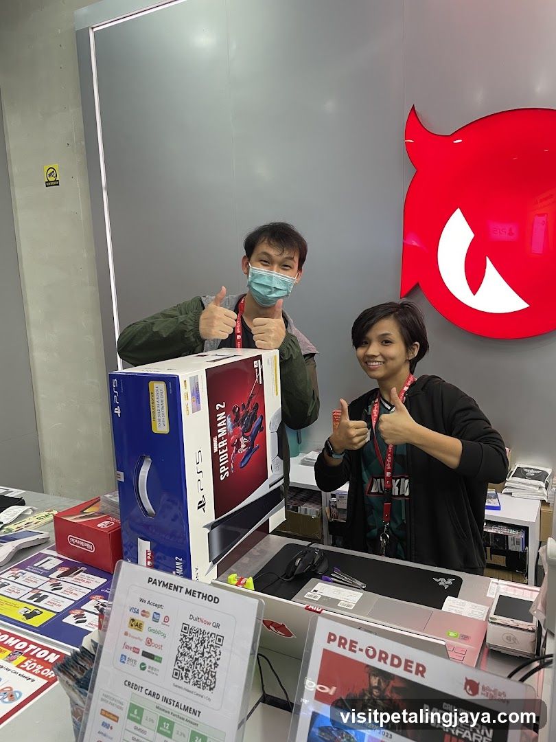 Two people giving thumbs up with game boxes