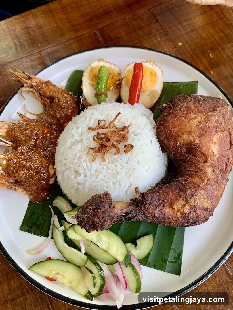 Plate of food with rice, fried chicken, prawns, and salad