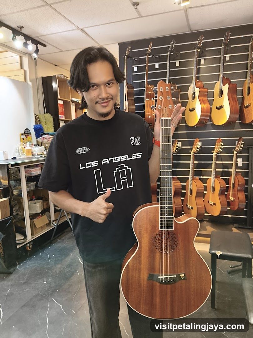 Man holding a guitar in a music store