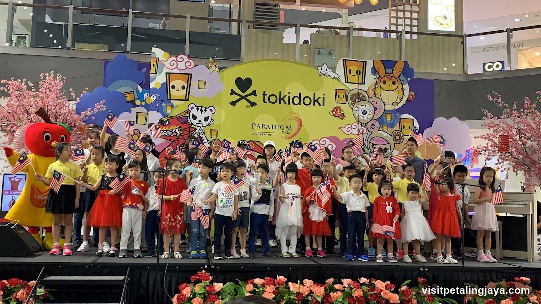 Children waving Malaysian flags at a Tokidoki event
