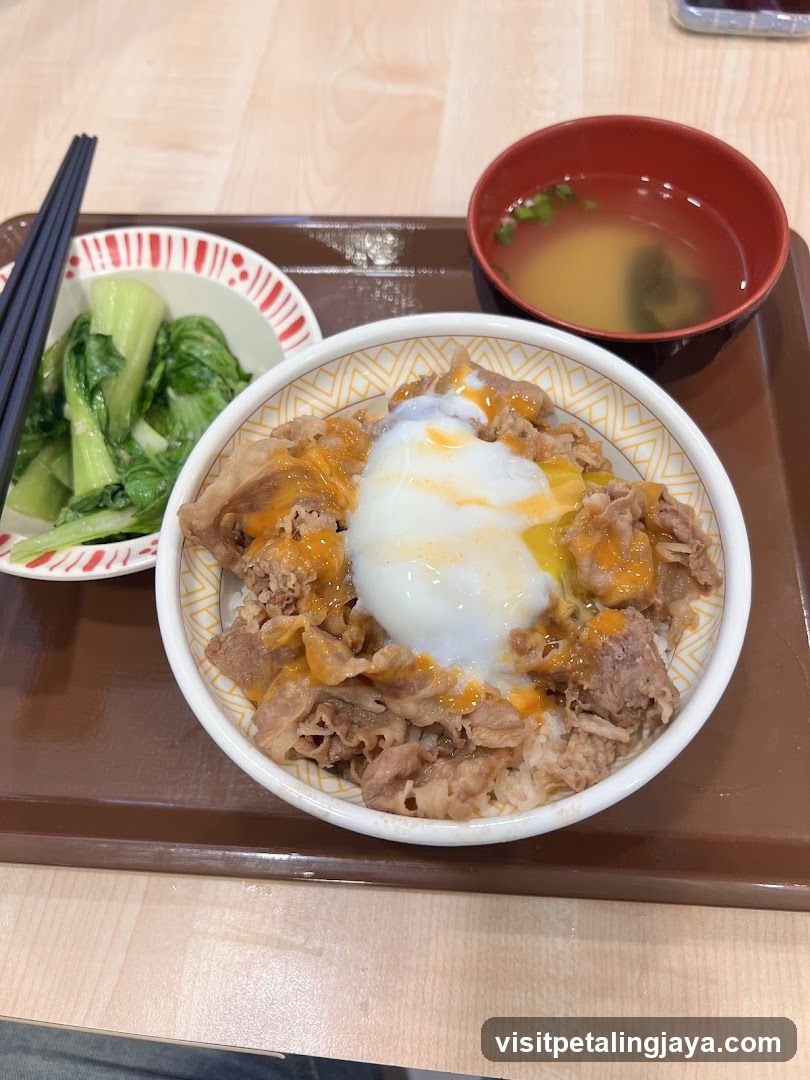 Beef bowl with egg and side of greens