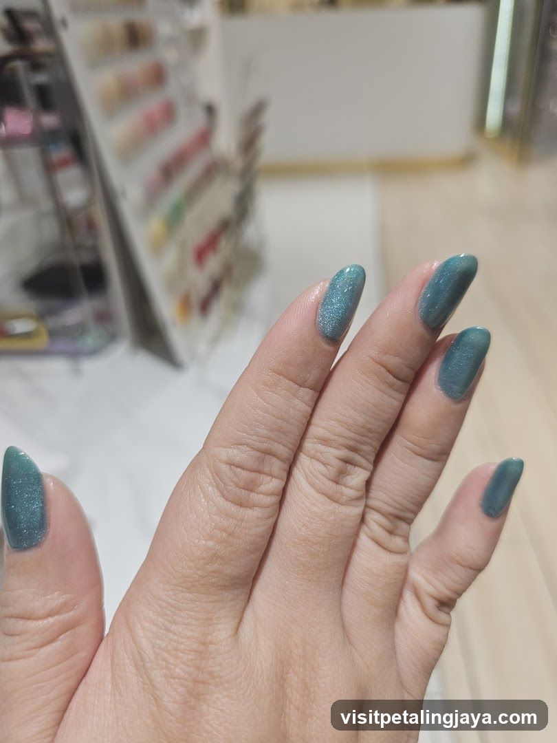 Hand with Teal Nail Polish