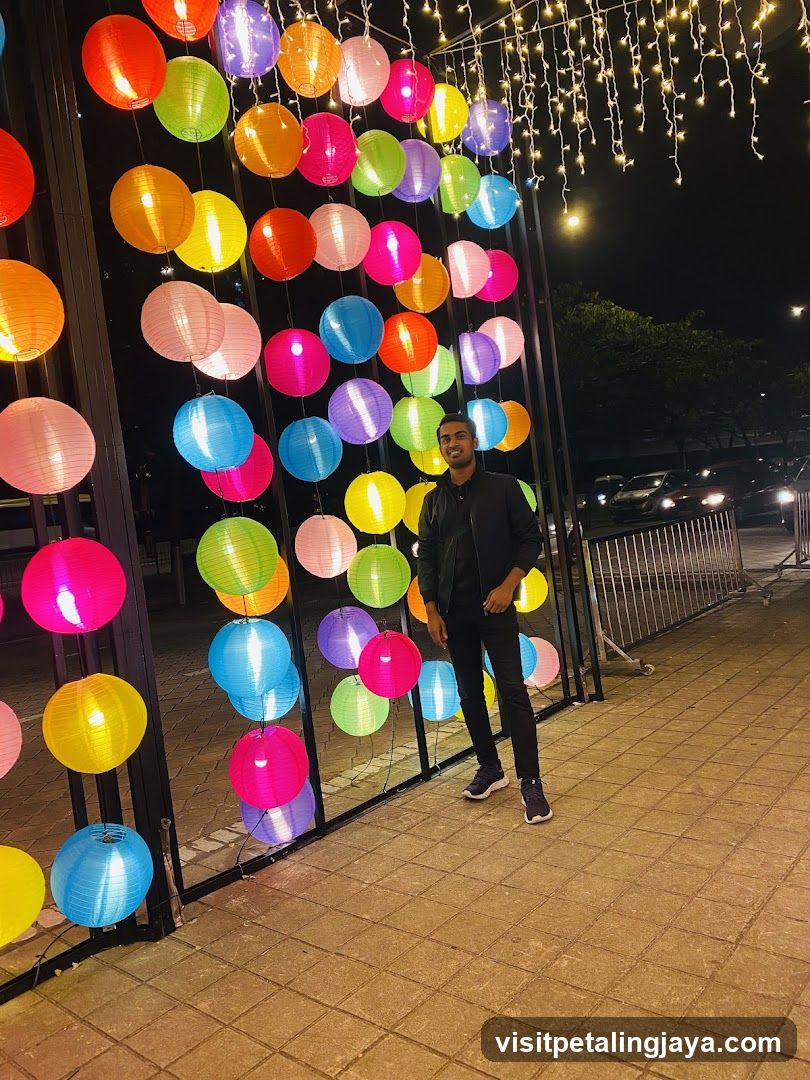 Man Posing in Front of Colorful Lanterns