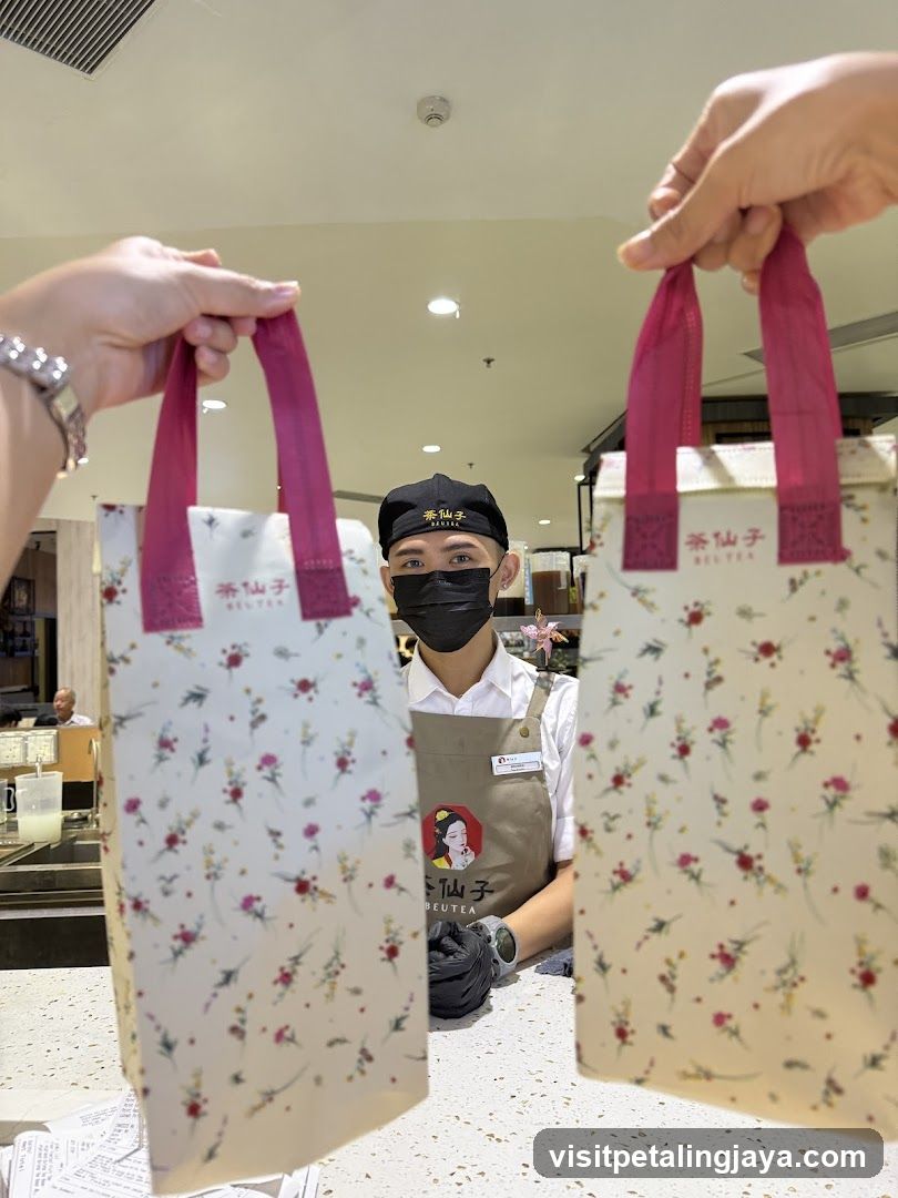 Beverage Shop Staff Holding Branded Bags