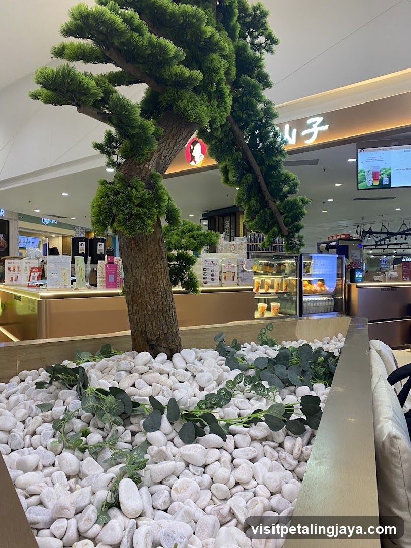 Indoor seating area with decorative tree and cafe counter