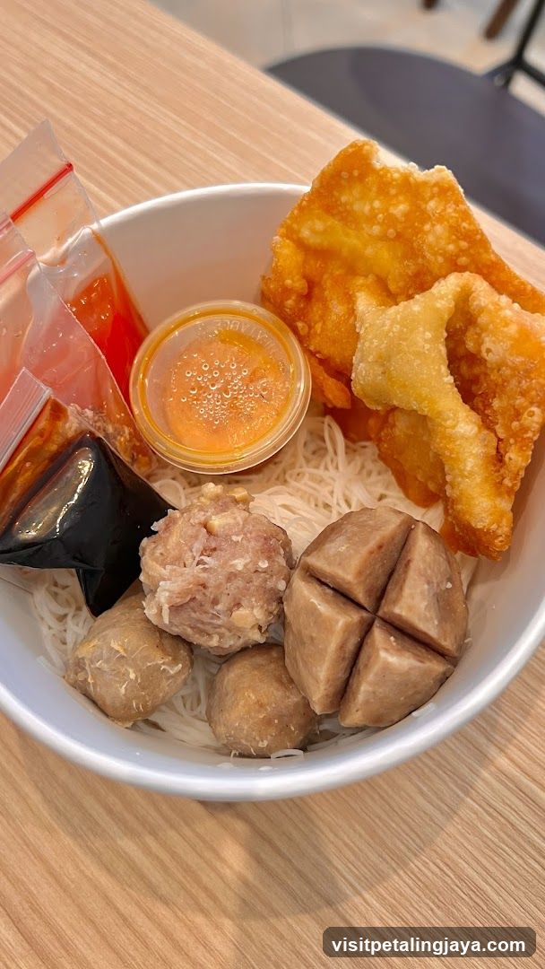 Bowl of Noodles with Meatballs and Fried Wontons