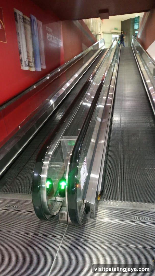 Escalator with Money Exchange Signage