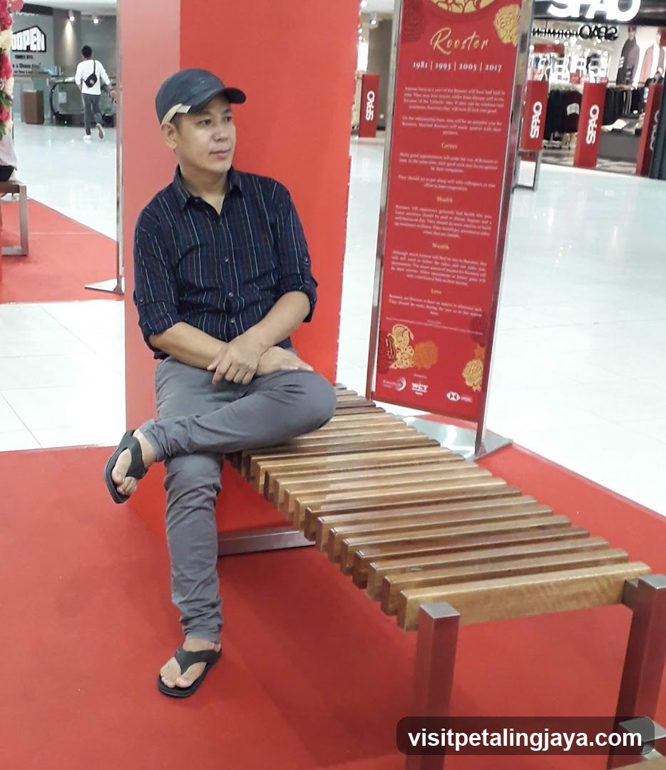 Man sitting on a bench in a mall