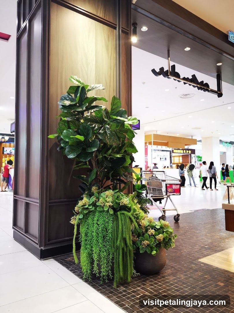 Indoor mall decor with plants and signage