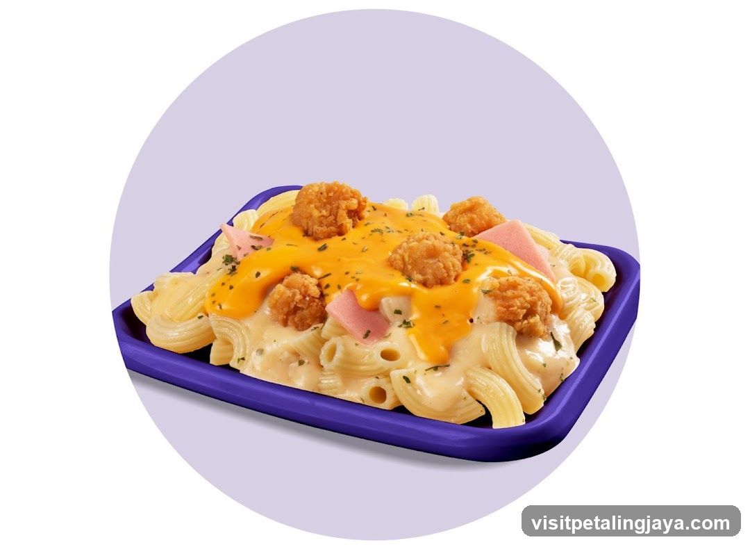 Macaroni with cheese sauce and fried chicken bites