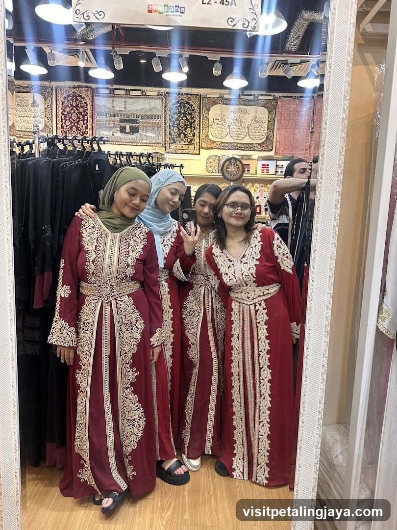 Four women in traditional attire posing for a mirror selfie