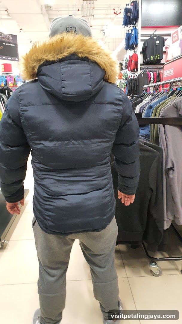 Man wearing a puffer jacket in a clothing store
