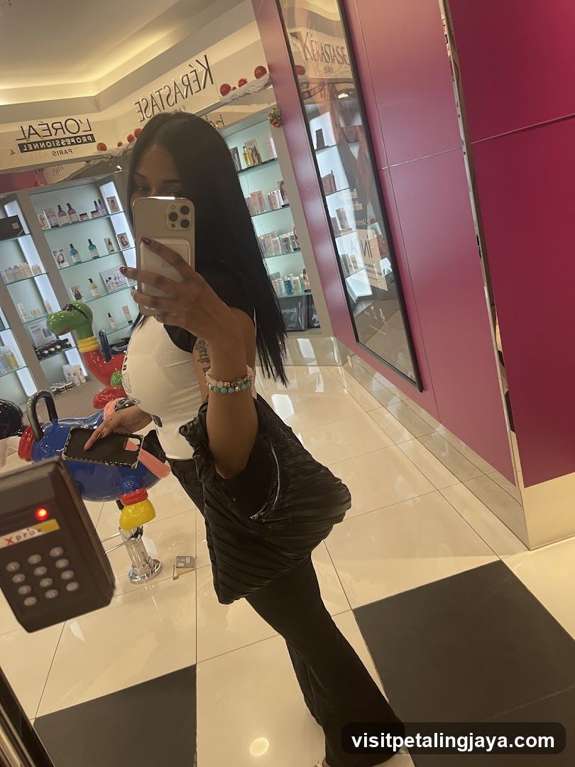 Woman taking a mirror selfie in a salon