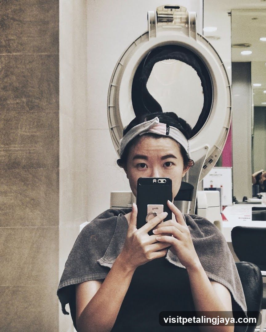 Woman taking a selfie under a hair dryer