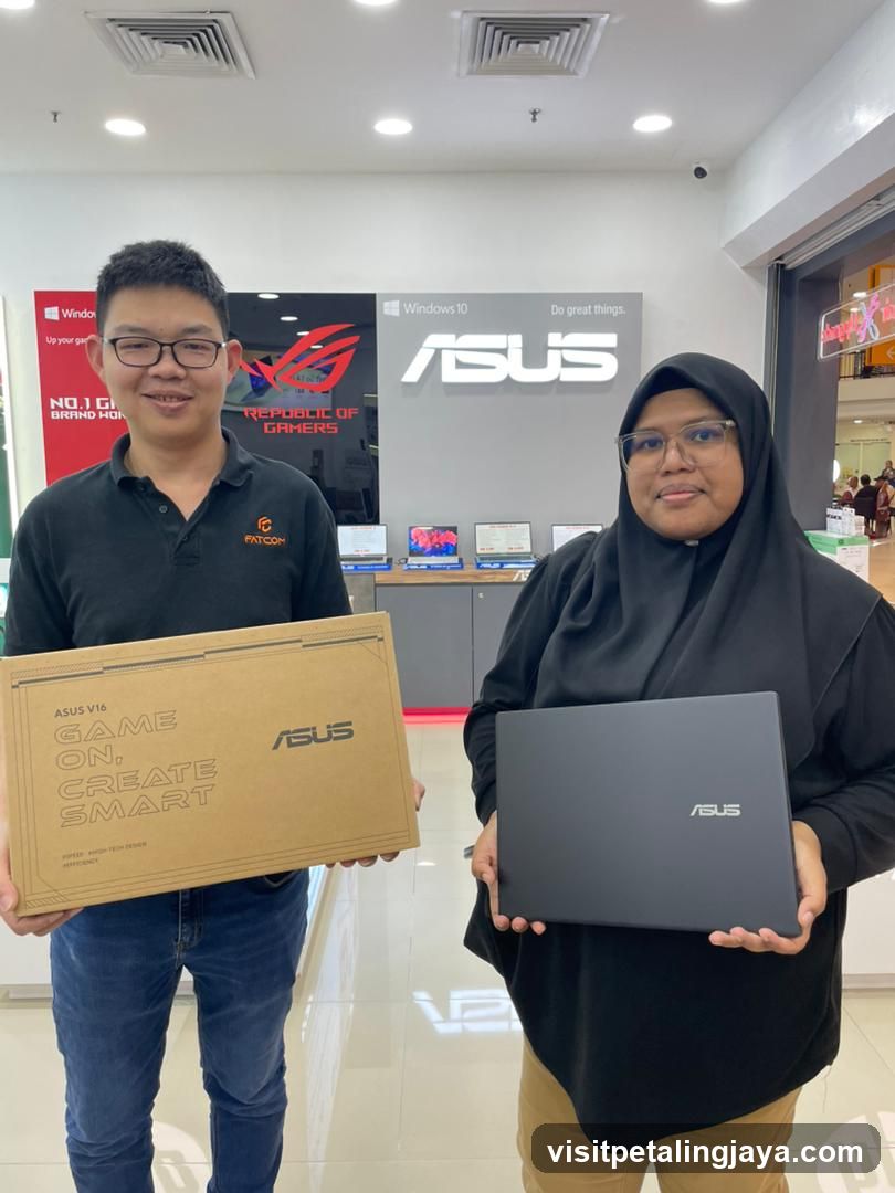 Two people holding ASUS products