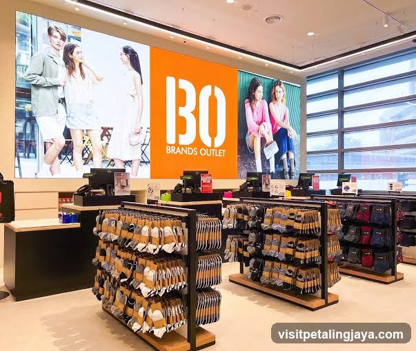 Clothing store interior with large digital display