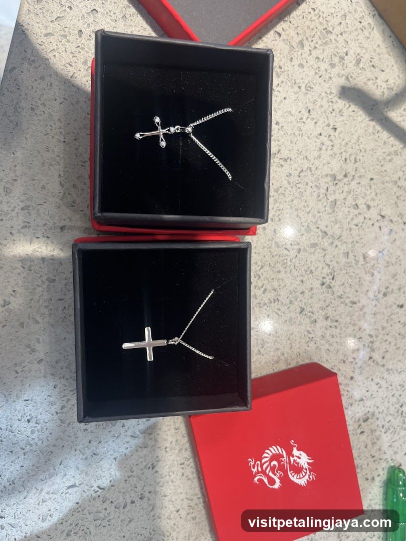Two cross necklaces in boxes