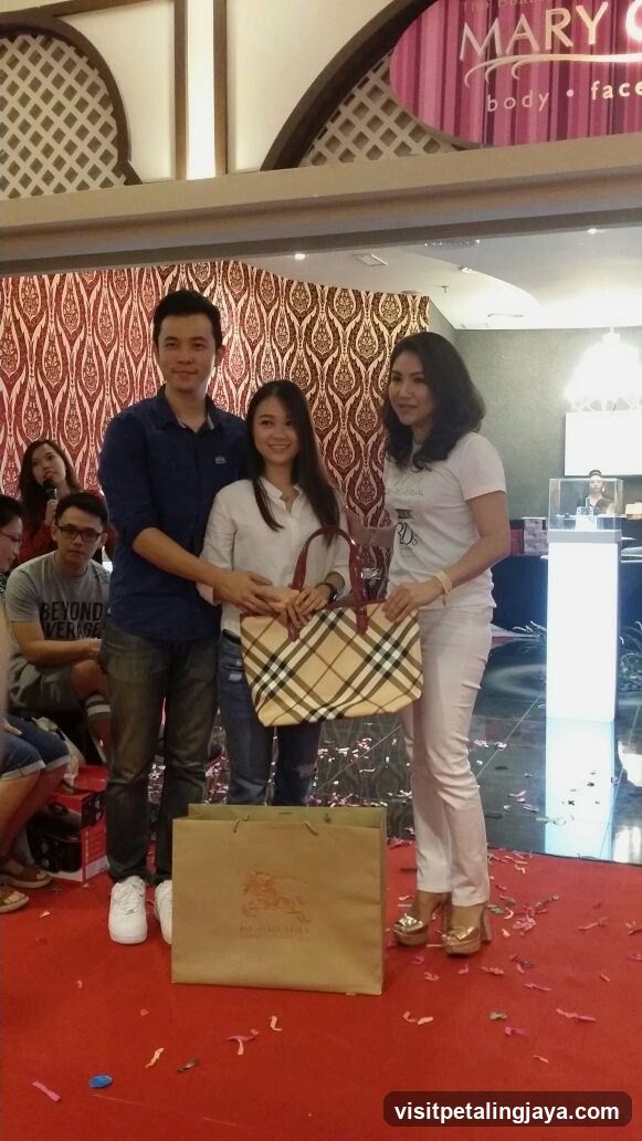 People posing with a handbag and shopping bag
