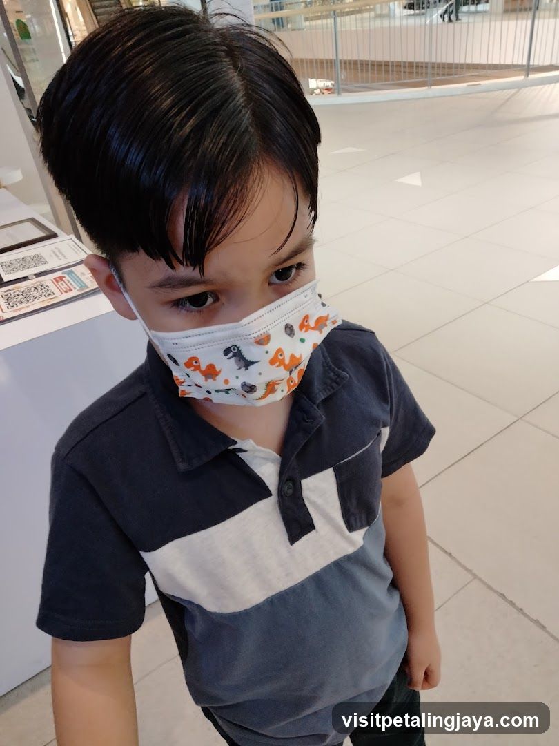 Boy wearing a dinosaur mask