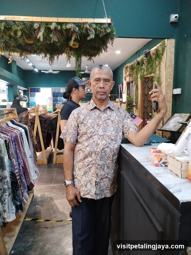 Man in a patterned shirt standing in a store