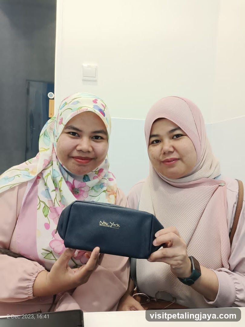 Two Women Holding a Pouch