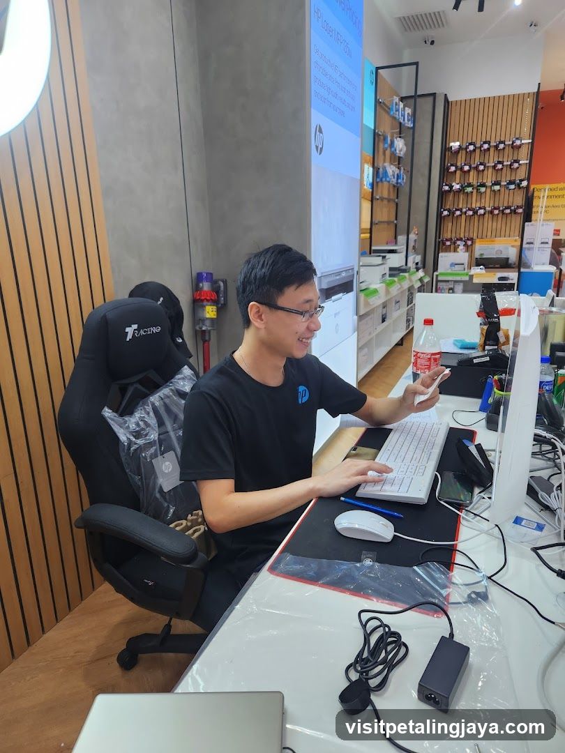 Man working at a computer in a store