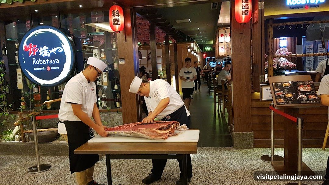 Chefs preparing a large fish