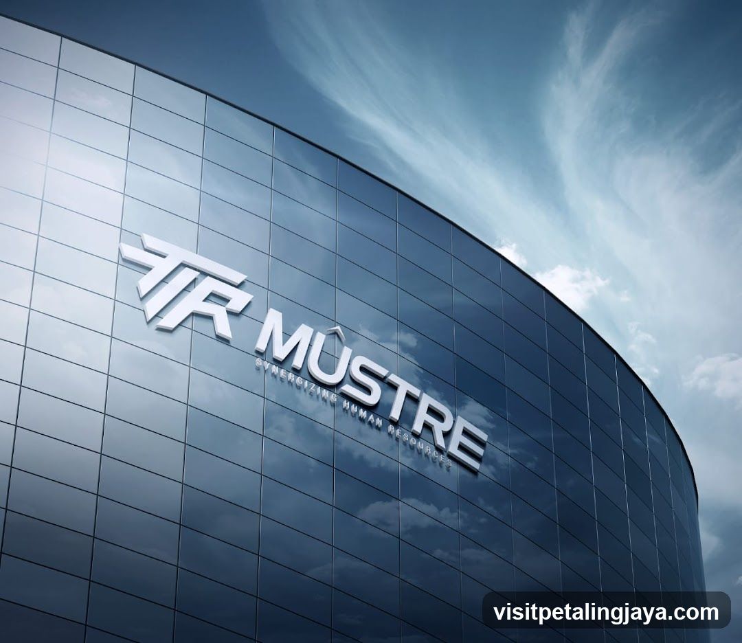 A sleek, modern building with a glass facade reflects the sky and clouds. A prominent white logo with the text "TR MUSTRE" and the tagline "SYNERGIZING HUMAN RESOURCES" is mounted on the building's exterior.
