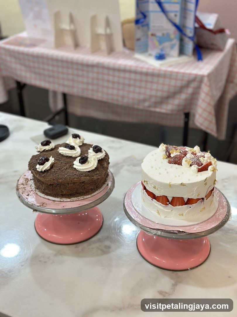 Two decorated cakes on display stands